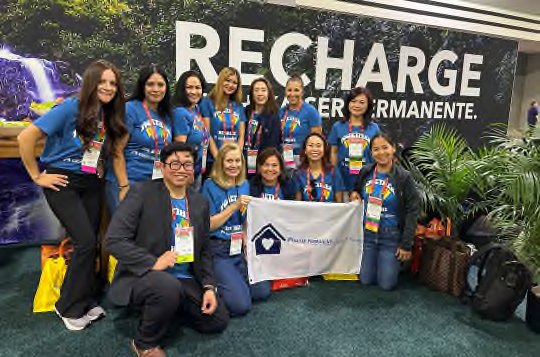 A Care at Home team celebrating together in matching shirts